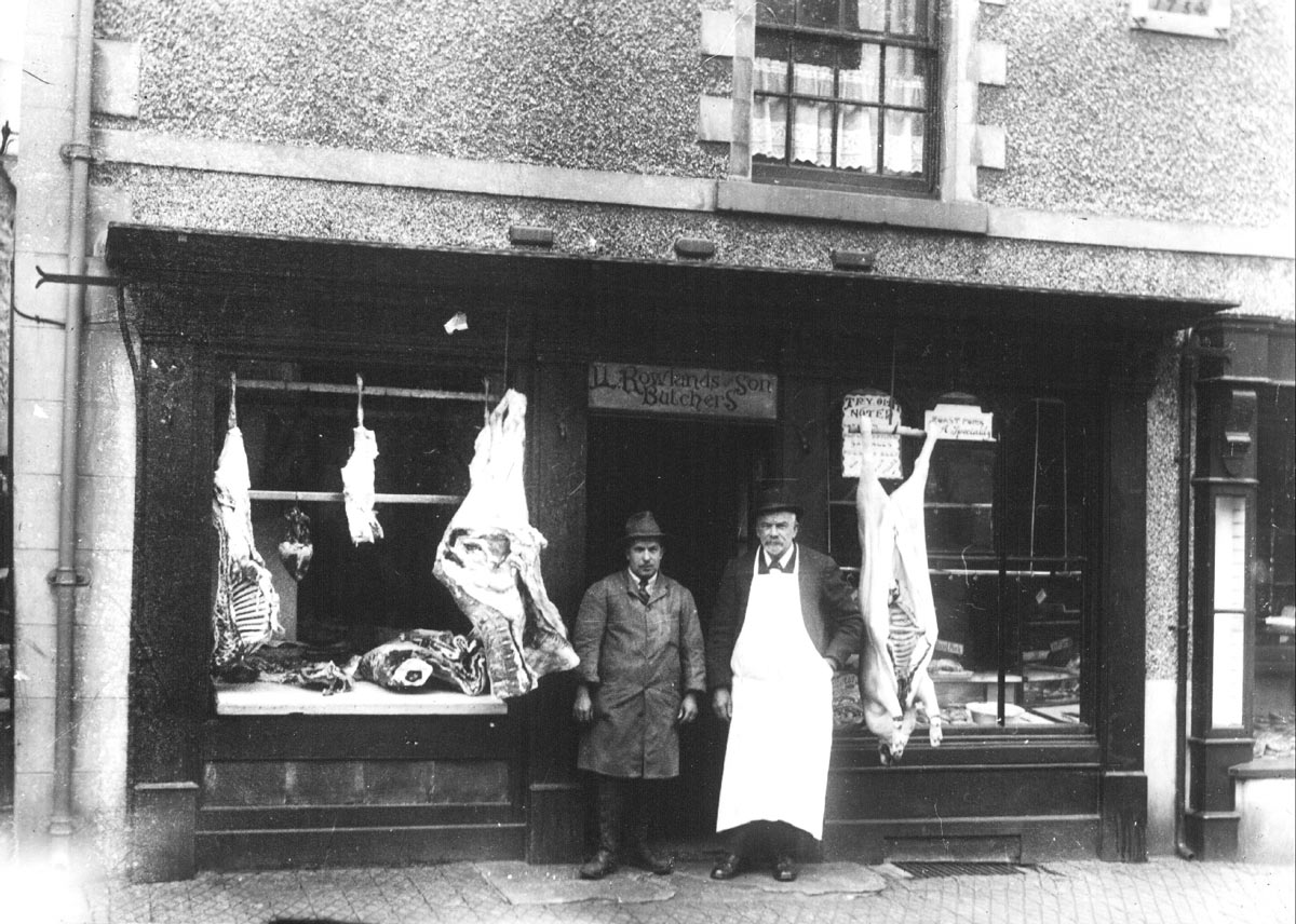 Llewelyn Rowlands butchers on Bridge Street. On the left is Morris Williams and on the right Llewelyn Rowlands